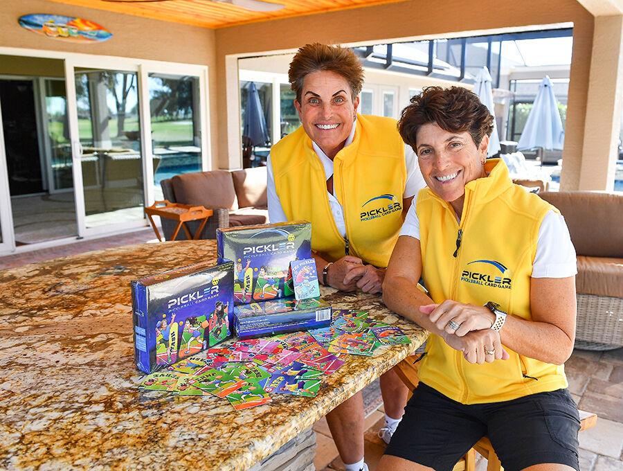 Linda Webb and Randy Friedman, of the Village of Fernandina, sit next to the card game they created. 
India Pantin, Daily Sun